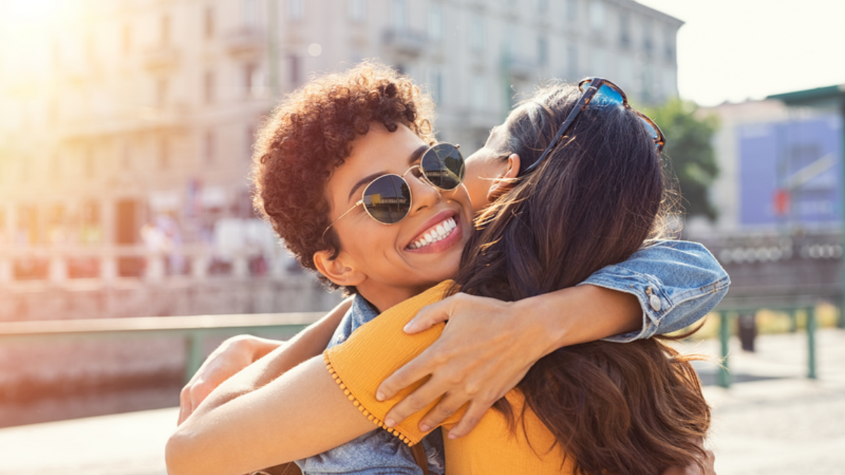 Two friends embracing in a warm hug.